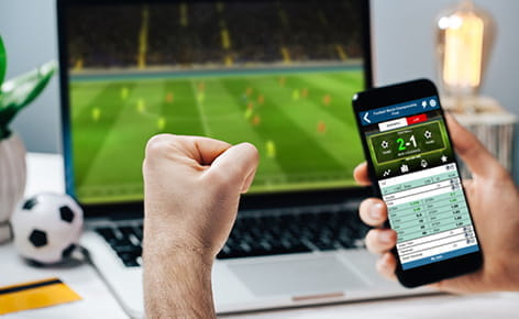 Mobiel wedden terwijl je naar een voetbalwedstrijd kijkt