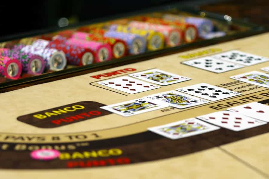A baccarat casino table game with dealt cards.