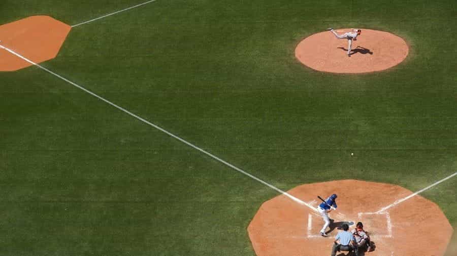 A pitcher throws ball to batter in baseball game.