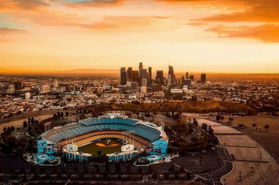 An empty dodger stadium amidst the Los Angeles skyline.