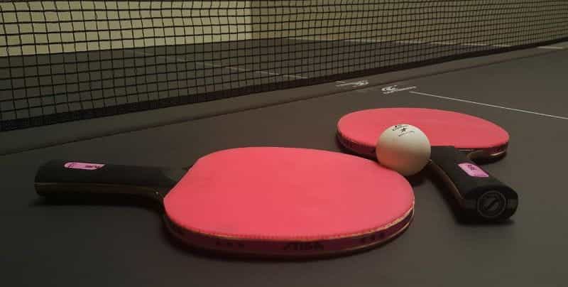 Table tennis paddles and ball.