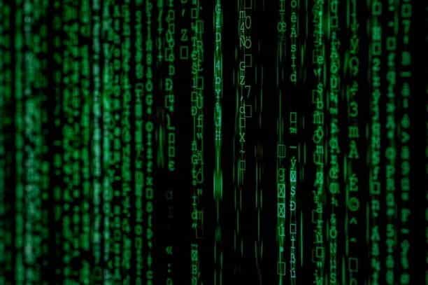 A black computer screen with green matrix style letters.