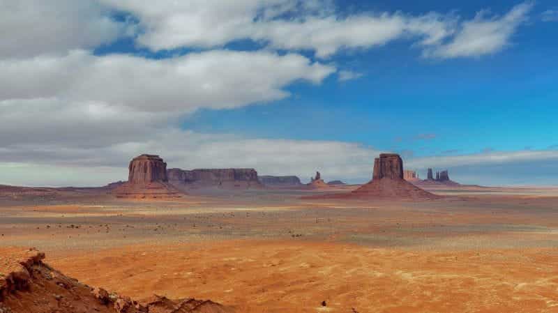 The badlands and desert in the state of Arizona, with buttes and mountains seen in the distance.