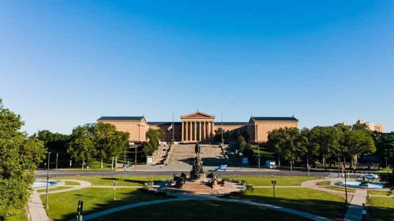 Philadelphia Museum of Art, next to trees, grass and fountains.