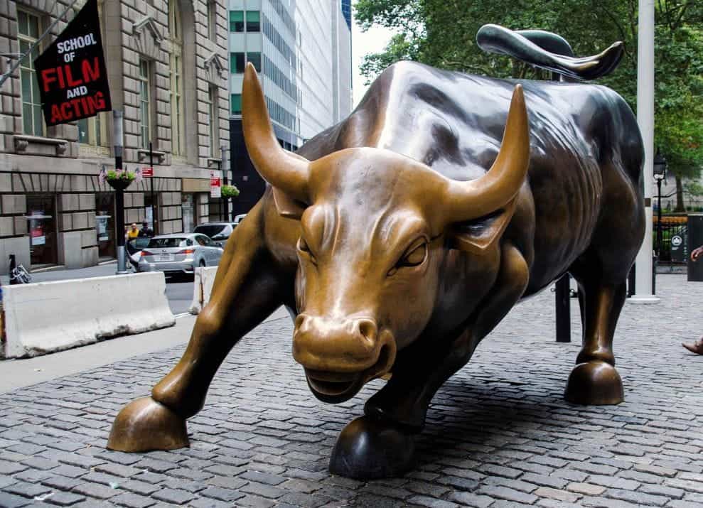 The iconic bronze bull state in front of the New York Stock Exchange (NYSE) on Wall Street in Manhattan, New York, United States of America.
