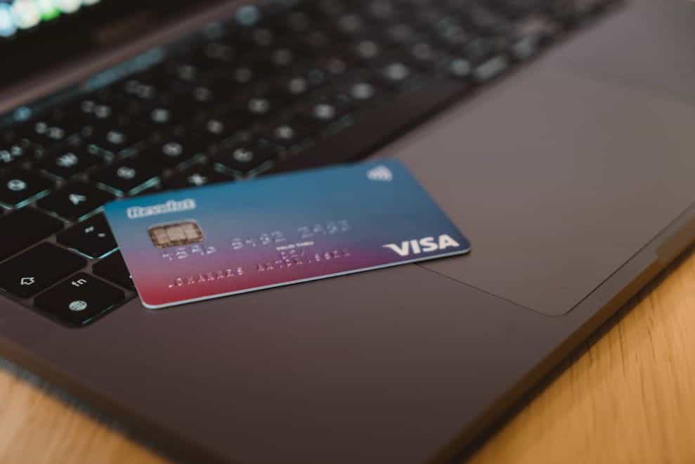 A credit card placed at the edge of an open laptop.