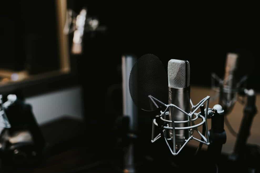 A microphone broadcast setup in a dark room.