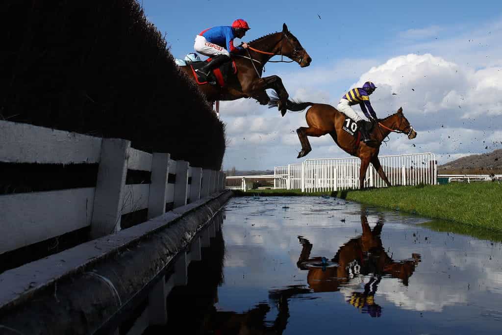 Corach Rambler takes the water jump on his way to winning the 2023 Ultima Handicap Chase.