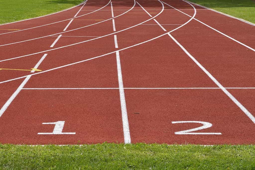 A clay outdoor athletic field featuring two running lanes labeled ‘1’ and ‘2’ respectively.