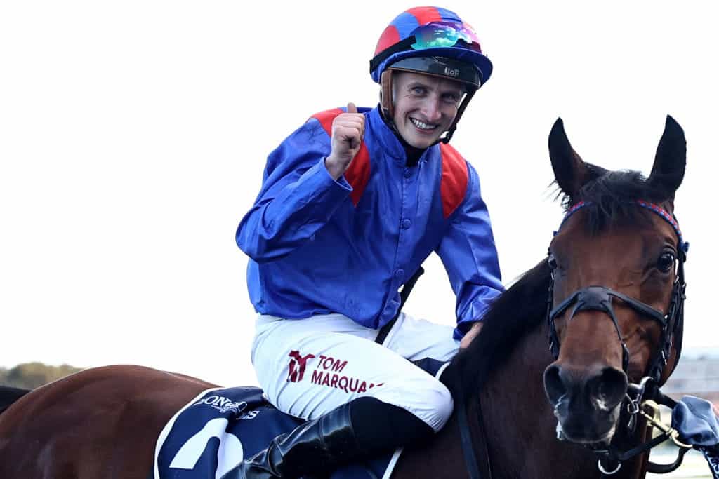 Tom Marquand celebrates after riding Dubai Honour to success in the 2023 Longines Queen Elizabeth Stakes.