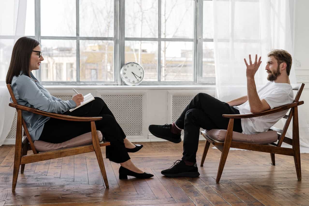 A therapist talking to a patient.