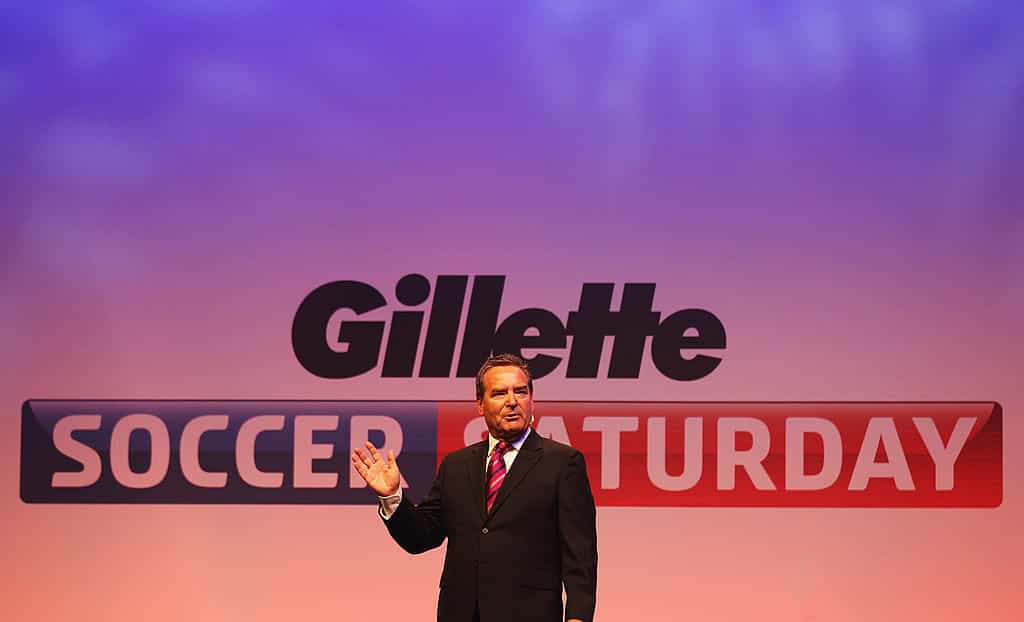 Jeff Stelling standing in front of a Sky Soccer Saturday sign.